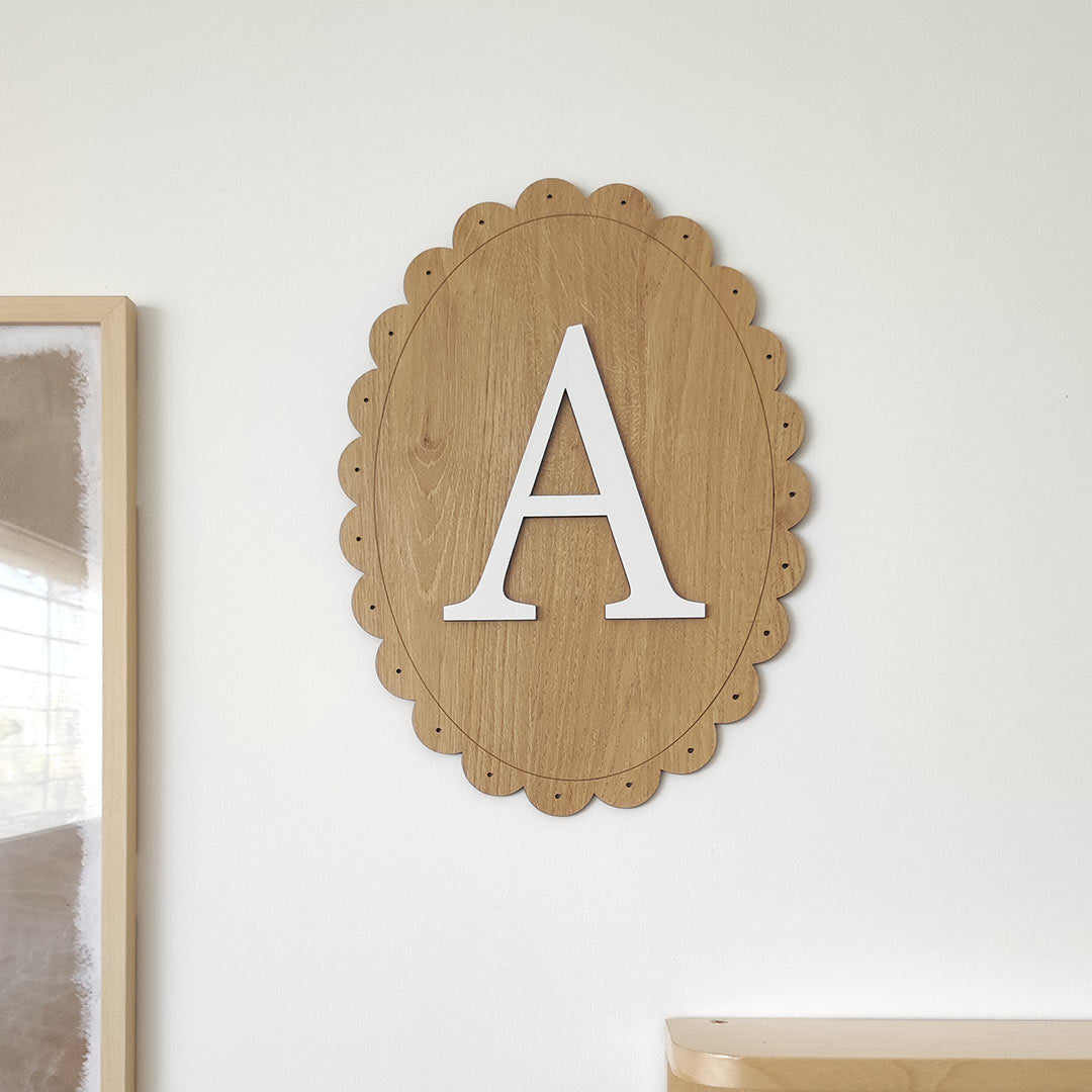 Name sign for a child's room – oval wooden sign with letter