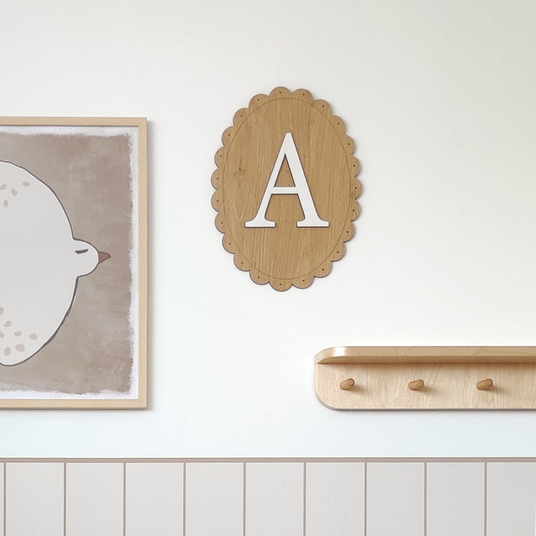 Name sign for a child's room – oval wooden sign with letter