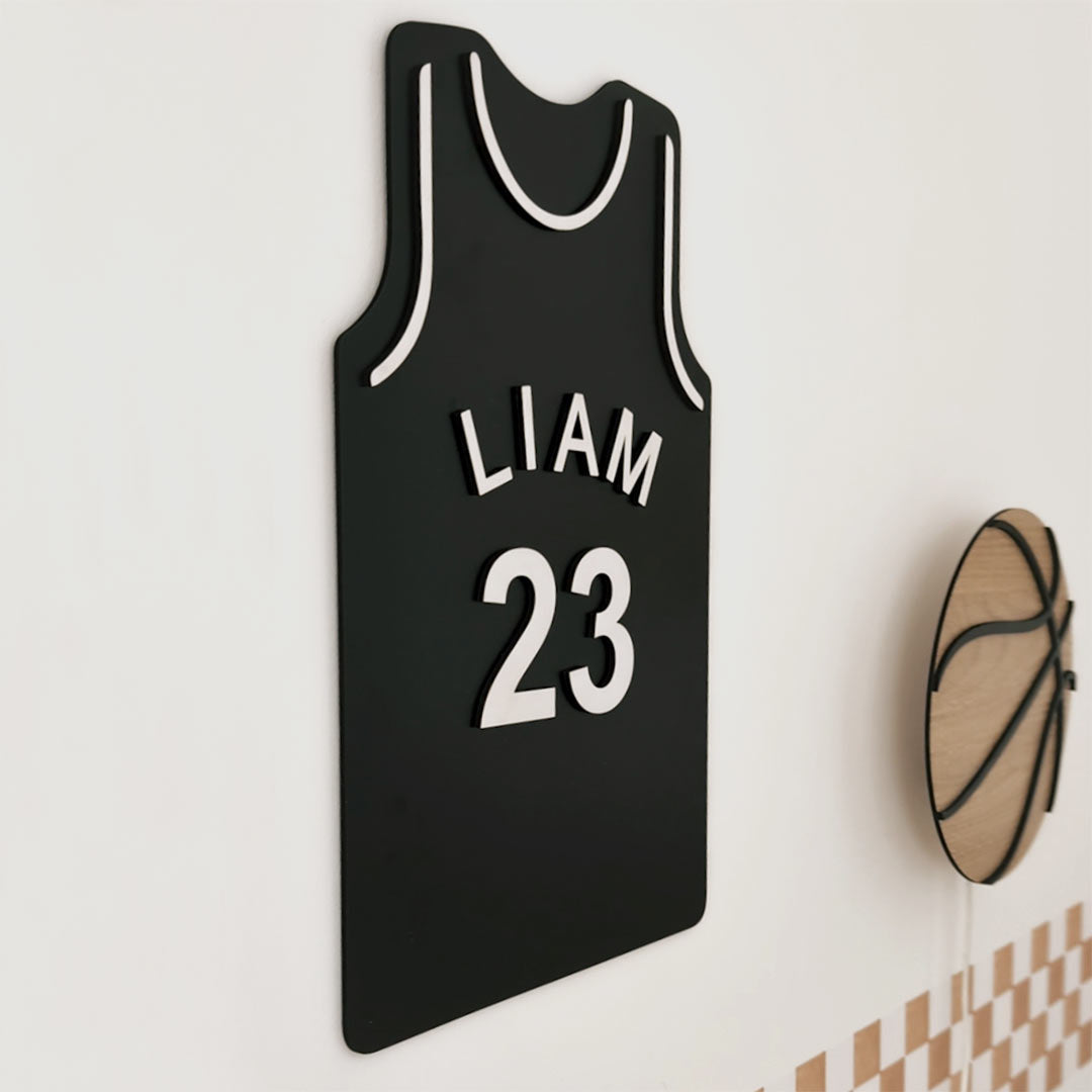 Basketball jersey with the child's name on a wooden hanger